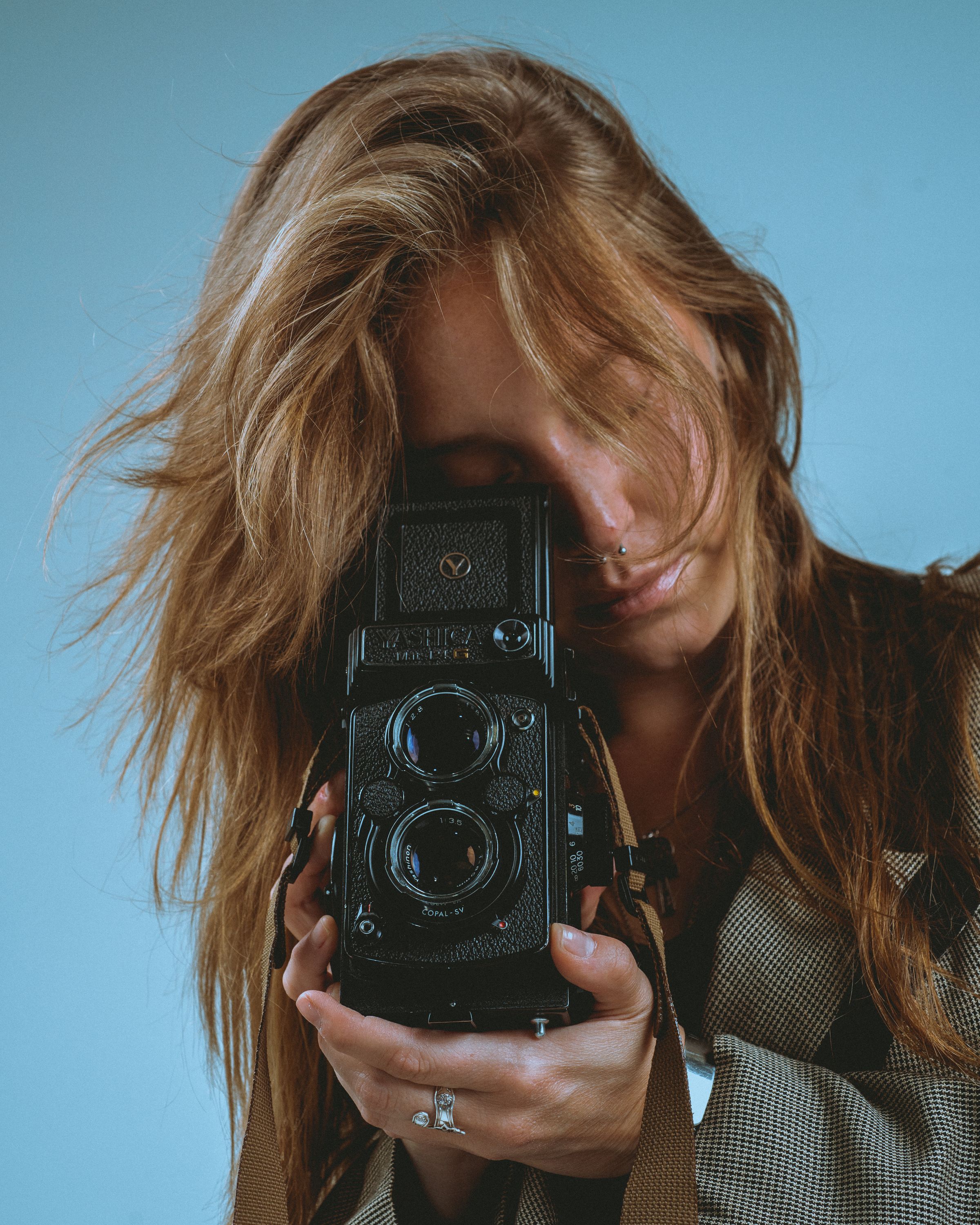 Sophie behind a twin-lens reflex camera, face hidden